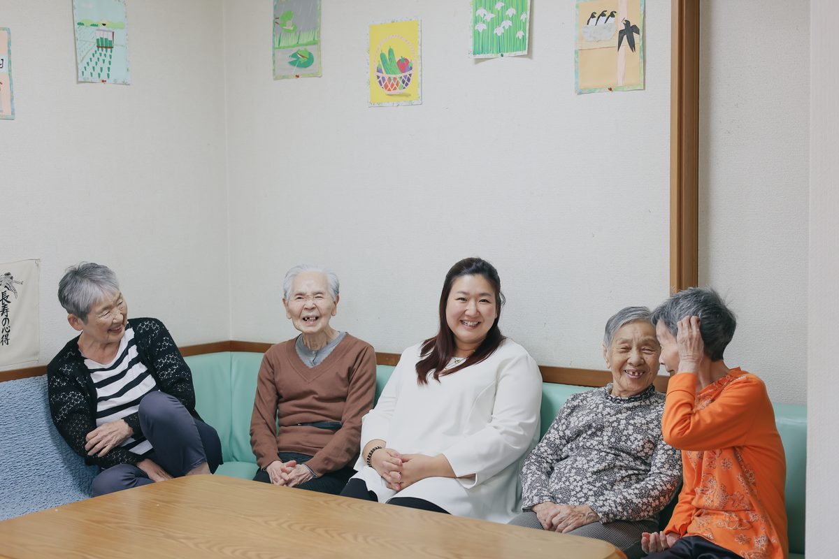 居間で談笑する入居者様とスタッフ